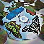 Click/tap for more details of Butterfly Biscornu (cross stitch) by Meridian Designs
