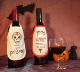 Click/tap for more details of Halloween Wine Bottle Aprons (cross stitch) by Julie Lynes