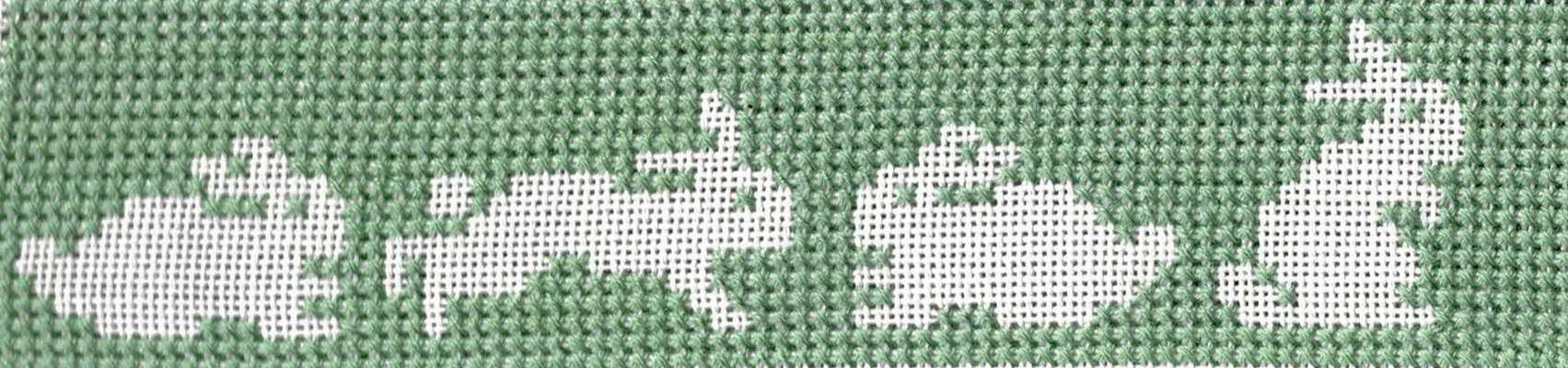 Click/tap for more details of White Rabbits (cross stitch) by Anne Peden