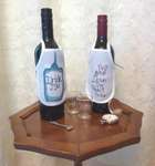 Click/tap for more details of Wonderland Bottle Aprons (cross stitch) by Julie Lynes